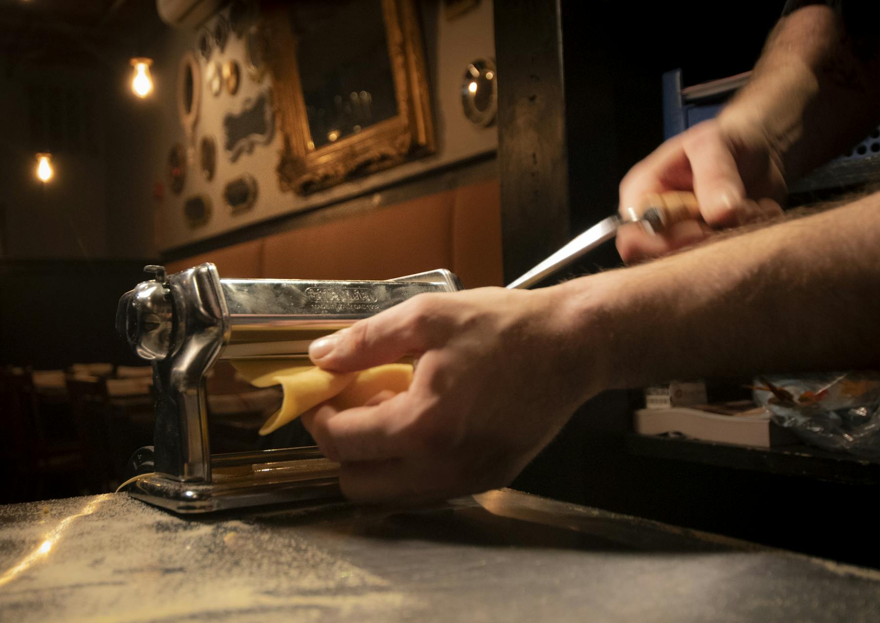 a man holding a slice of cheese